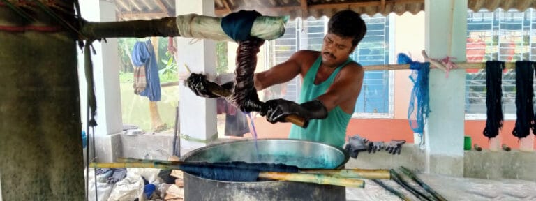 A man dyeing yarn at Chhandabroti Weavers