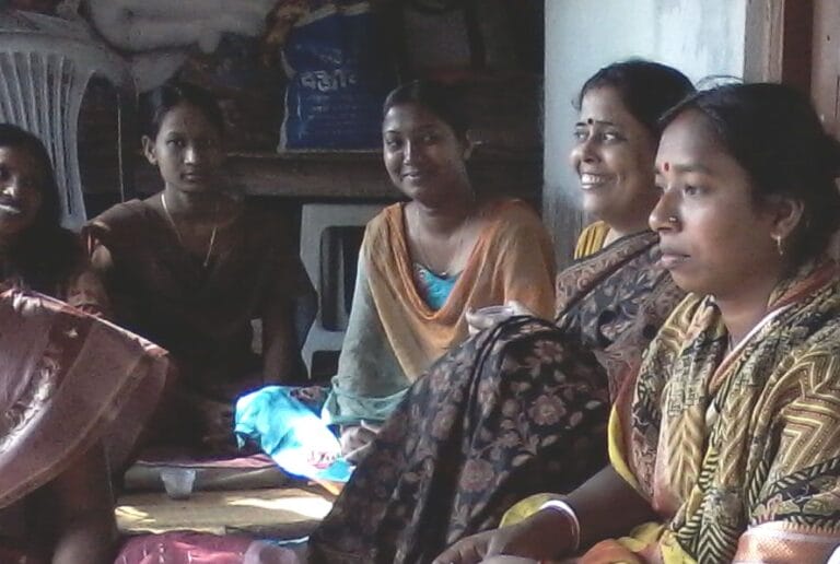 Group of women sitting indoors in conversation during a SSA capacity building session