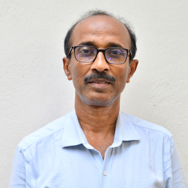 Man wearing glasses and light blue shirt